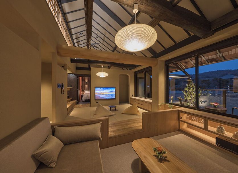 Wakasa Annex in Nara, tatami-style room with lounge seating and large window mountain view