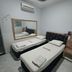 Hotel Flert Santana in Sao Paulo guest room with two single beds, wall mirror, and air conditioner