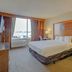 Capital O Duncanville Tx guest room with king bed, desk and window view in Duncanville