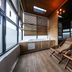 Daegu Innovalley in Daegu: wood-paneled spa room with hot tub and lounge chairs overlooking city views