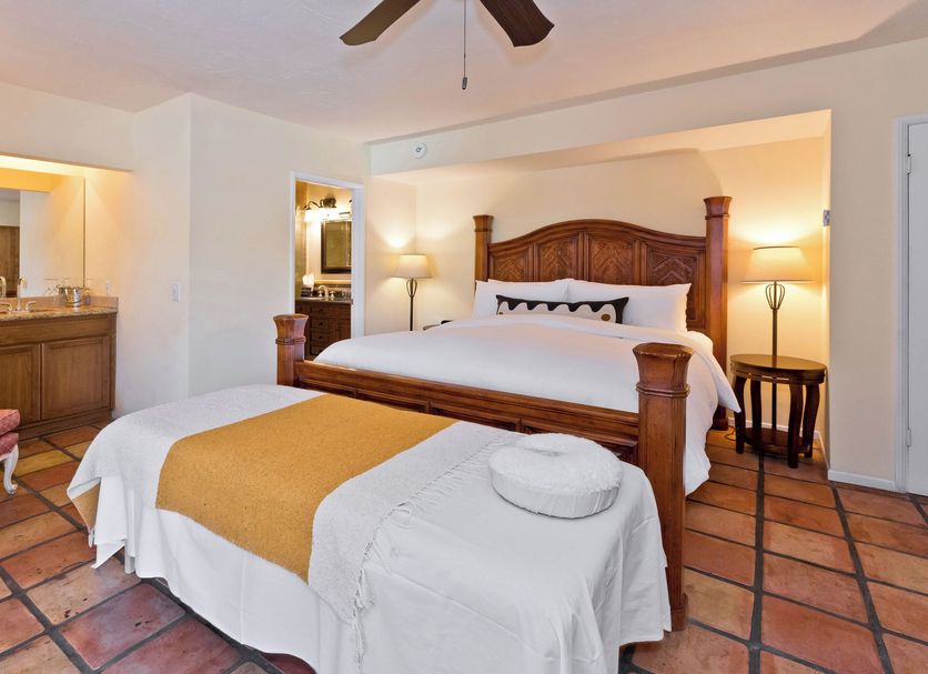 La Maison Hotel - Adults Only Palm Springs bedroom with four-poster bed, terracotta tile floor and vanity