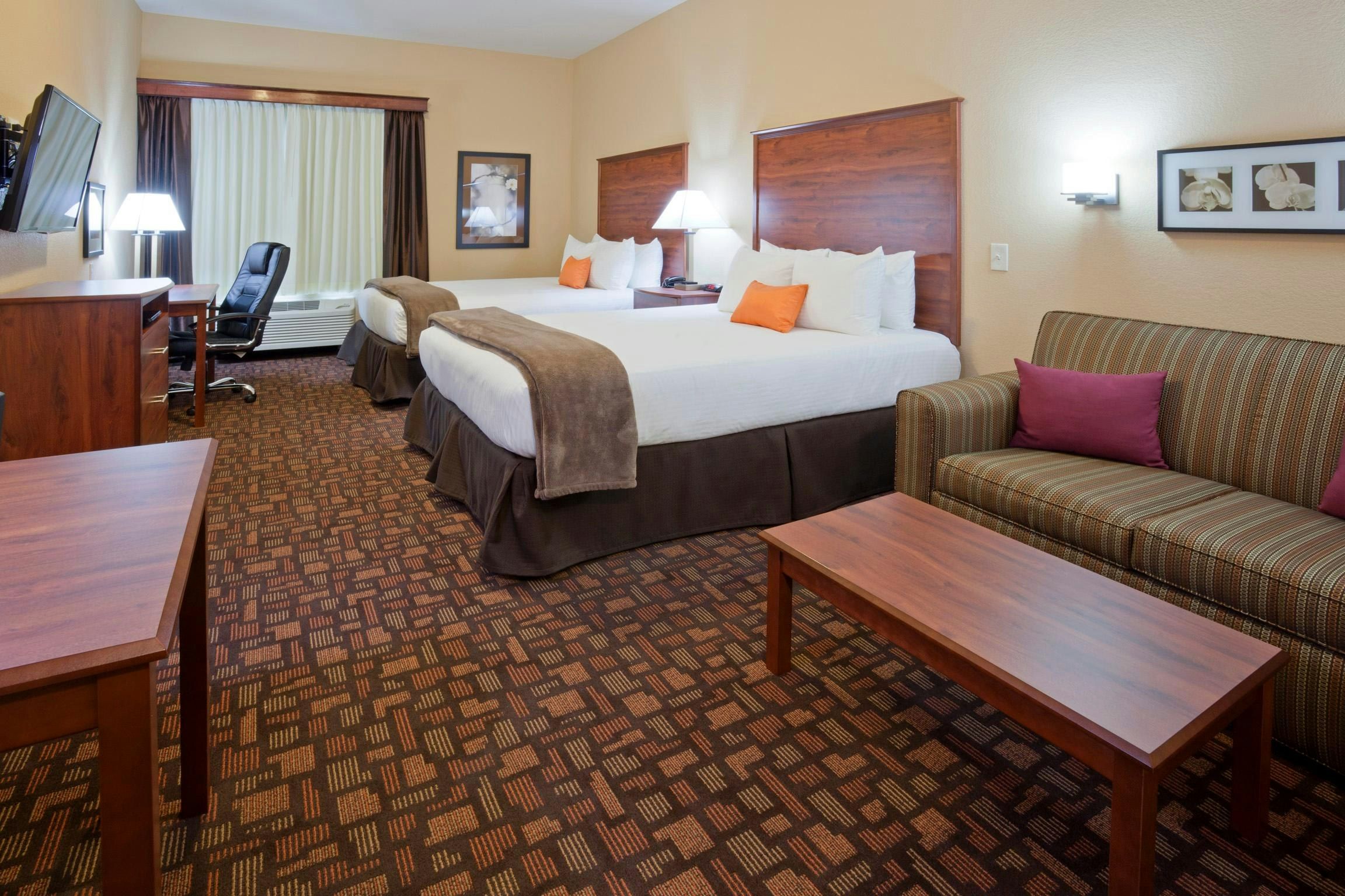 Grand Forks Lodge and Suites in Grand Forks: guest room with two beds, sofa, desk, and chair