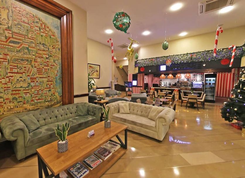Antik Hotel Istanbul lobby with sofas, coffee table and festive bar seating in Istanbul