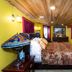 Stone Manor Boutique Inn in Lovettsville: colorful guest room with bed, wood ceiling, and wall-mounted TV