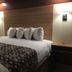Seahorse Inn in Wildwood guest room with a king bed, bedside lamps, and patterned bed runner