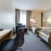 Tyrifjord Hotell in Vikersund guest room with two twin beds, chair by window, and desk