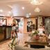 Aquarius Backpackers Resort, Byron Bay lobby lounge with guests seated on chairs and a bar counter