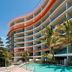 Silvershore Apartments on the Broadwater in Biggera Waters with curved balconies, palm trees and a pool