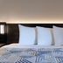 Studio 6 Pensacola, Fl- West I-10 bed with white pillows and geometric bedding
