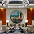 Hilton Dubai The Walk lobby seating area with circular wall art and modern lighting in Dubai
