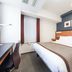 Hotel Mystays Sakaisuji Honmachi in Osaka guest room with queen bed, desk, and large window