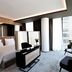 Grand Plaza Hotel & Congress Center Ljubljana suite with city-view windows, bed, seating area, and desk