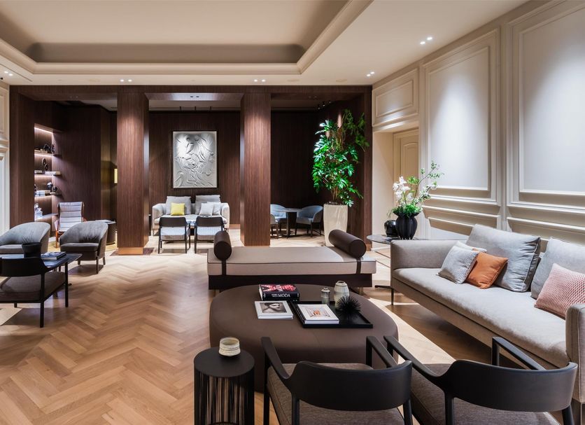 Worldhotel Cristoforo Colombo Milan lounge with seating, wood-paneled alcove, and herringbone floors