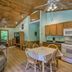 Nantahala Cabins in Bryson City living area with vaulted wood ceiling, kitchen, and dining table