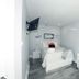 Serene Niagara Inn room in Niagara Falls with a bed, wall-mounted TV, vanity, and gray flooring