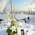 Mar Paraiso Queen in Acapulco: beachfront terrace wedding setup with white tables and chairs at sunset