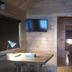 The Beach House in Mackinaw City guest room with desk, wall-mounted TV, and a view into a bedroom