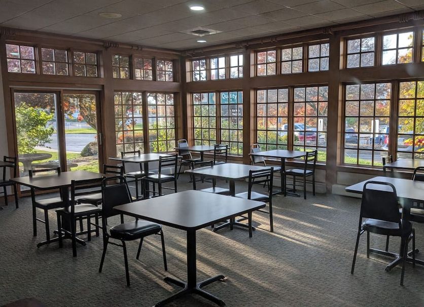 Quality Inn Pittsburgh Airport in Oakdale breakfast room with large windows and tables