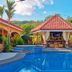 Las Brisas Resort and Villas in Jacó: tropical pool with swim-up cabana and palm trees
