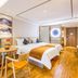 Shanshui Trends Hotel Shao Yao Ju Beijing guest room with twin beds, seating area and wood floors