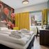 Thon Hotel Saga, Haugesund: colorful floral mural bedroom with double bed and city-view window