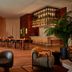 Lobby lounge at HOLLYWOOD VOLUME, a Tribute Portfolio Hotel in Los Angeles with bar seating and warm wood decor