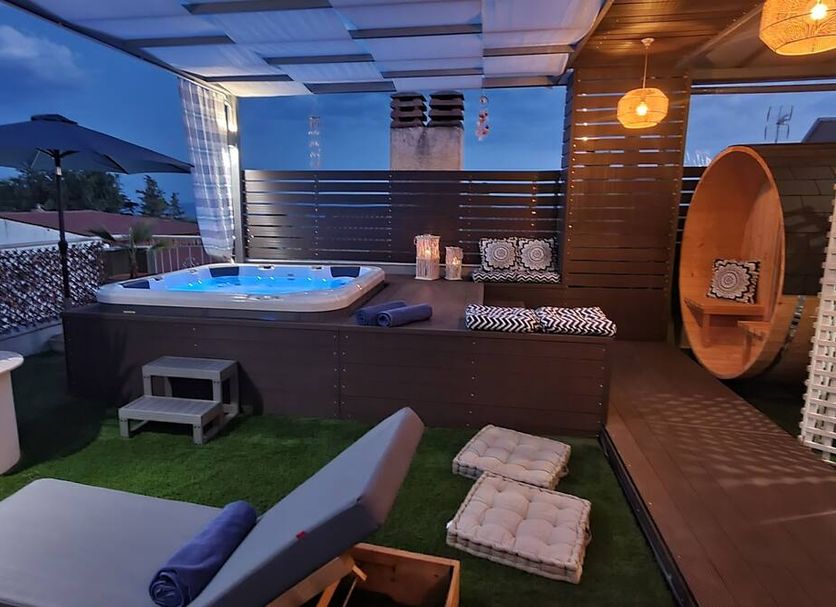 Hotel Mallas in Nea Kallikratia rooftop terrace with hot tub, lounge beds and canopy seating