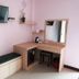 The Loom Rangsit room with wall-mounted TV, desk, mirror, mini fridge and bench in Pathum Thani