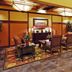 The Q Hotel & Suites in Springfield lobby seating area with patterned rug and warm wood accents