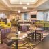 La Quinta Inn & Suites by Wyndham Fort Worth City View lobby seating area with tables and chairs