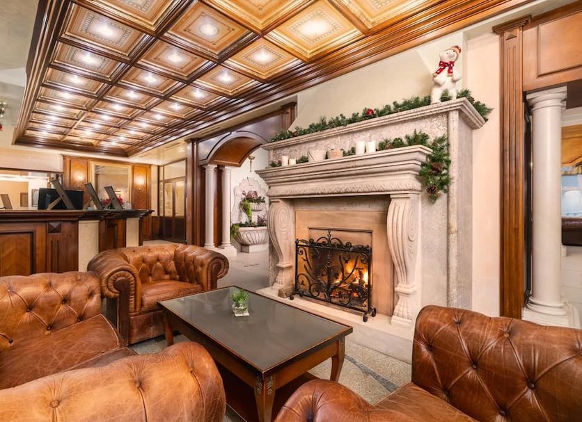 Festa Winter Palace Hotel in Borovets lobby with tufted leather chairs and ornate fireplace