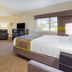 Emmetsburg Hotel & Suites room with king bed, recliner, TV, and in-room jetted tub in Emmetsburg