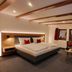 Gasthaus Staude in Triberg guest room with king bed, seating area and wall-mounted TV