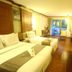 Ao Nang Beach Resort in Krabi: twin beds, wooden furnishings, and balcony doors to greenery
