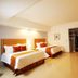Hb CÓrdoba in Córdoba guest room with two beds, open closet, desk and TV