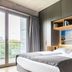 Downtown Apartments Mitte Berlin room with bed, balcony doors, and cityscape wall art