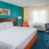 Fairfield Inn & Suites by Marriott Chicago Tinley Park guest room with king bed, desk, TV and window