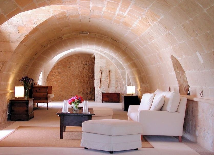 Son Mas Hotel Rural in Porto Cristo lounge with arched stone ceiling, white sofa and coffee table