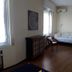 Il Riposo del Guerriero Guesthouse in Genoa room with sofa bed, chair, wooden cabinet and room divider