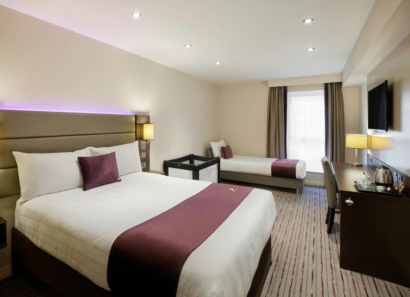 Premier Inn Thurrock West room with a double bed, twin bed, and wall-mounted TV in West Thurrock.