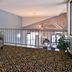 Wingate by Wyndham Beaver I-15 loft lounge area with gray sofa and patterned carpet in Beaver