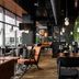 Original Sokos Hotel Arina in Oulu lounge dining area with plants, pendant lights, and wooden tables