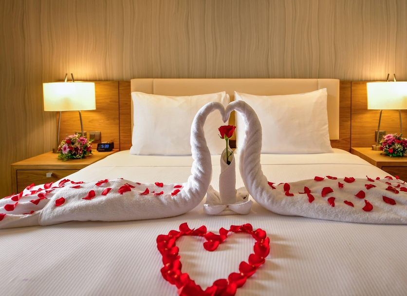 Clarion Hotel Jeddah Airport bed with rose petals and swan towel arrangement in Jeddah