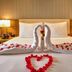 Clarion Hotel Jeddah Airport bed with rose petals and swan towel arrangement in Jeddah