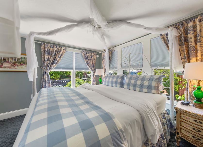 Aerie Bed & Breakfast in New Bern bedroom with four-poster bed and large windows overlooking greenery