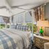 Aerie Bed & Breakfast in New Bern bedroom with four-poster bed and large windows overlooking greenery