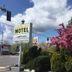 Diamond View Motel in Susanville sign with pink flowering tree, shrubs and blue sky