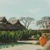Pousada Topázio in Fernando de Noronha with palm thatched huts and a small pool surrounded by greenery