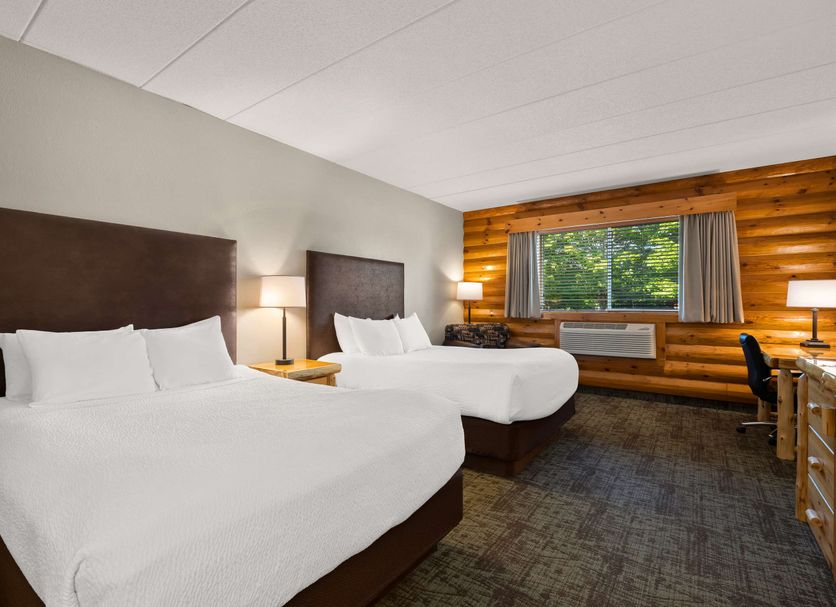 Best Western Northwoods Lodge Siren guest room with two beds and forest view through large window