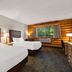 Best Western Northwoods Lodge Siren guest room with two beds and forest view through large window